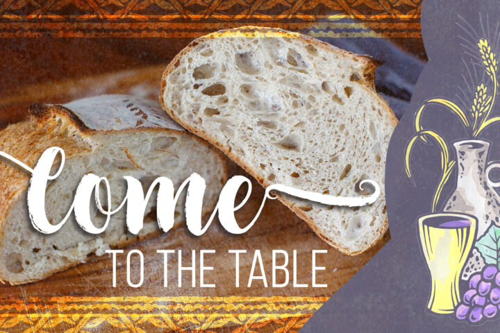Sliced rustic loaf of bread on a wooden board with the words 'Come to the table' and a wine and grape illustration on a purple panel to the right.